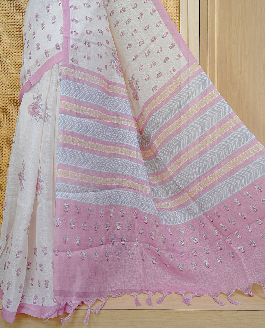Cream colour semi linen saree featuring Floral printed buttas on body, complemented by contrast Pink colour border, comes with matching blouse piece.