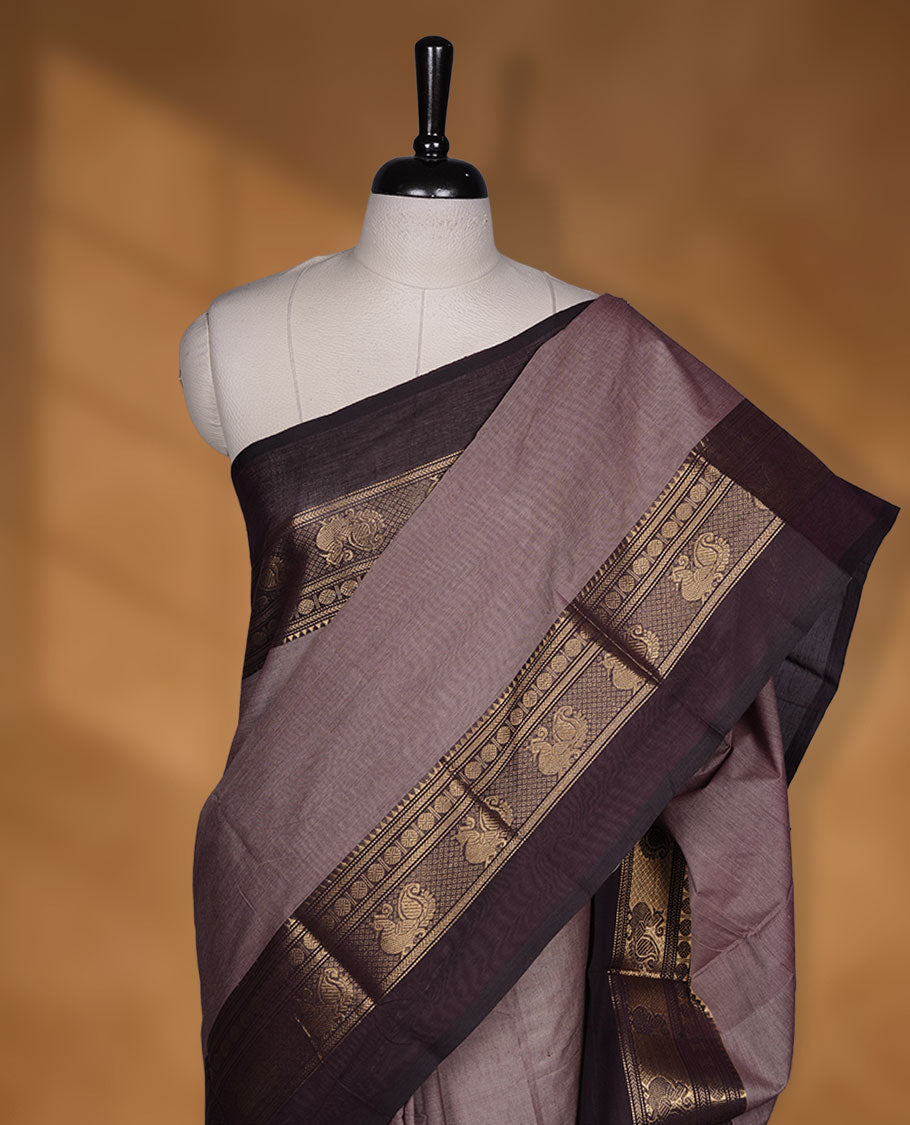 French beige colour chettinad cotton saree featuring plain body, contrast chocolate brown colour with traditional gold zari border without blouse.