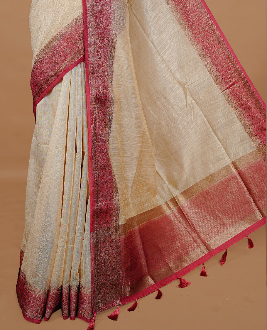 Biege colour Semi linen saree featuring Elegant plain body, complemented by contrast Maroon colour With Antique zari border, paired with matching blouse piece.