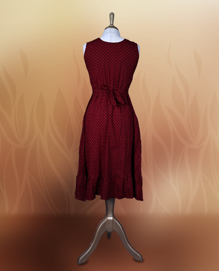 Dark maroon colour nightwear with orange colour polka dots, V neckline, and flutter sleeves & The flared hem with pleats adds a chic touch, Ideal for casual wear, office looks, or relaxed outings with a stylish twist.