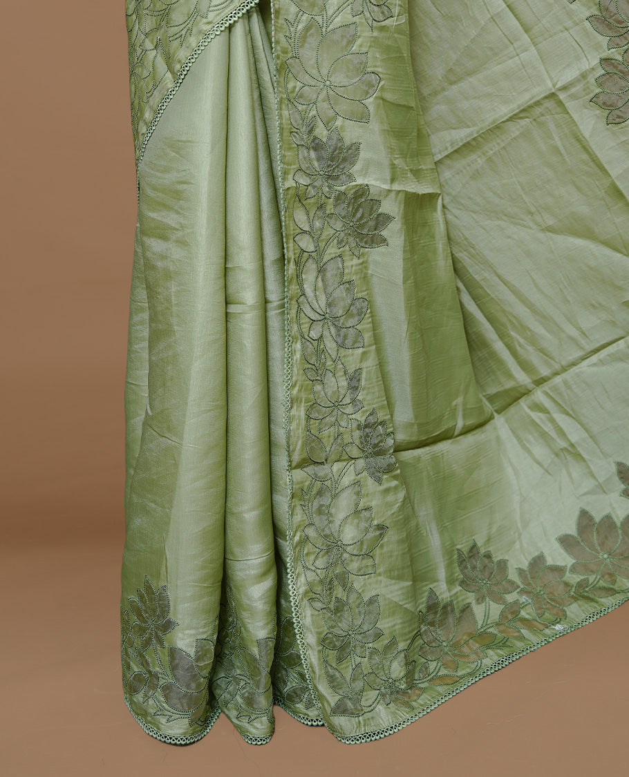 Pastel Green colour Designer saree Featuring Elegant plain body, enhance with thread Lotus Pattern with lace border, paired with matching blouse piece.