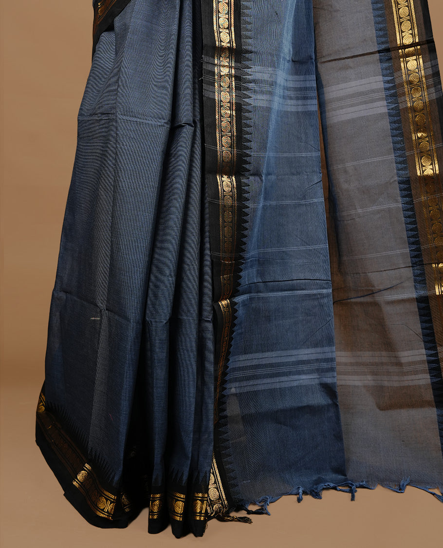 Bluish grey colour chettinad cotton saree featuring elegant plain body, complemented by black colour with zari border, paired with matching blouse piece.