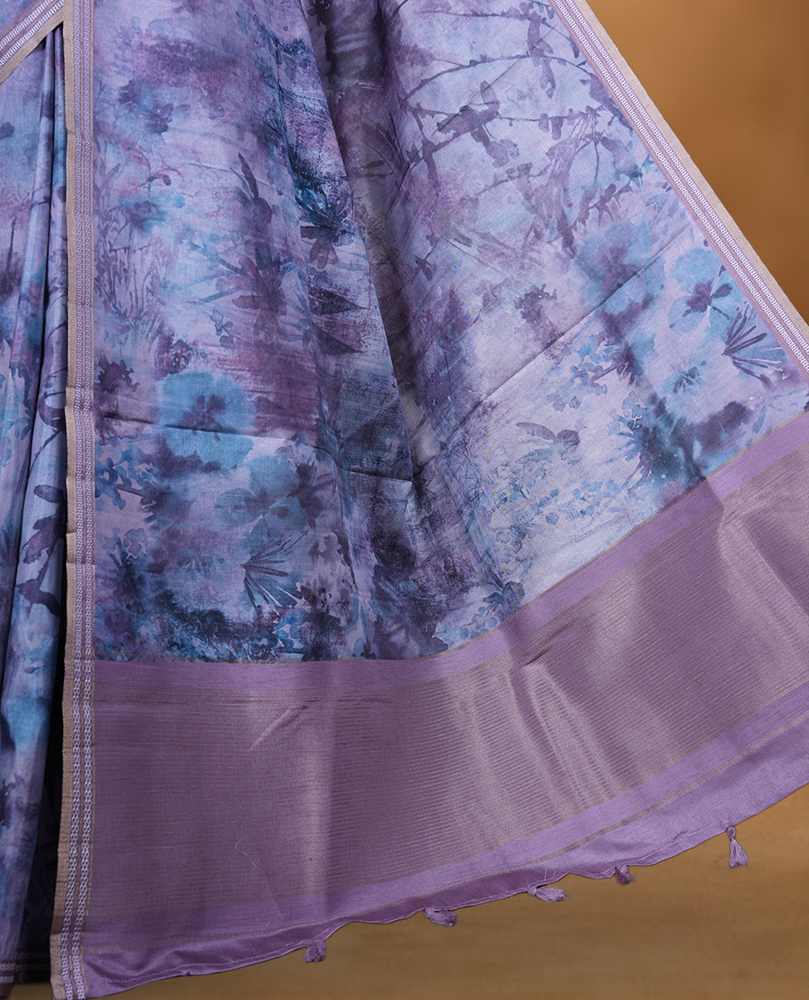 Lavender Purple colour semi tussar silk saree featuring an abstract digital floral printed body with a rich self border and tasselled pallu, paired with a matching blouse