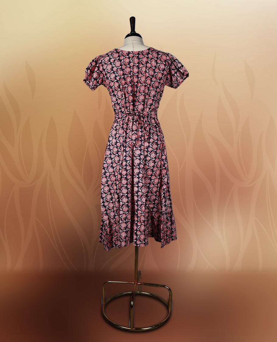 Black colour nightwear adorned with soft pink floral prints, featuring a V neckline, short sleeves, and a flared ruffle hem, A stylish and comfortable choice for daily wear, brunches, or casual outings.