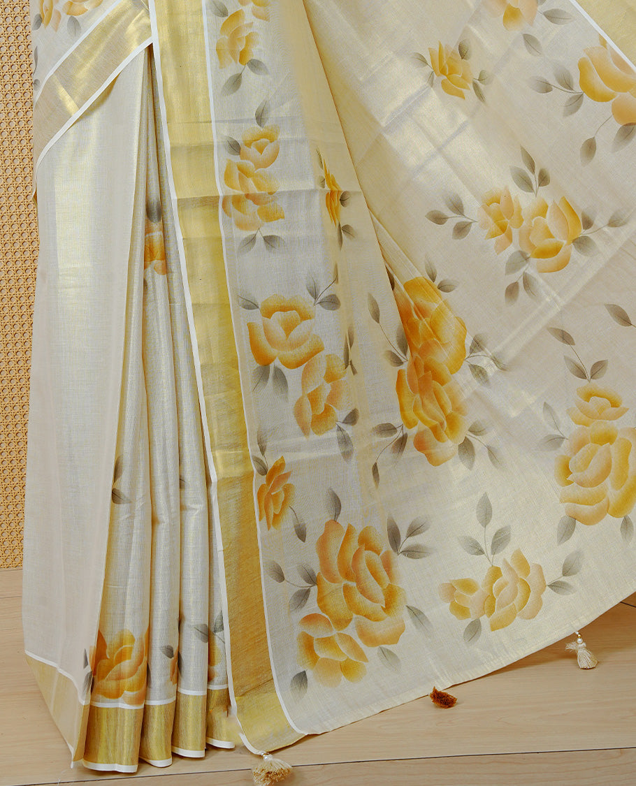 Cream Colour Tissue Kerala Saree Featuring Vibrant Floral Digital Printed Border & Pallu , Beautifully Enhanced With A Classic Gold Zari Border And Contrast Tassels. Paired With A Matching Blouse Piece.