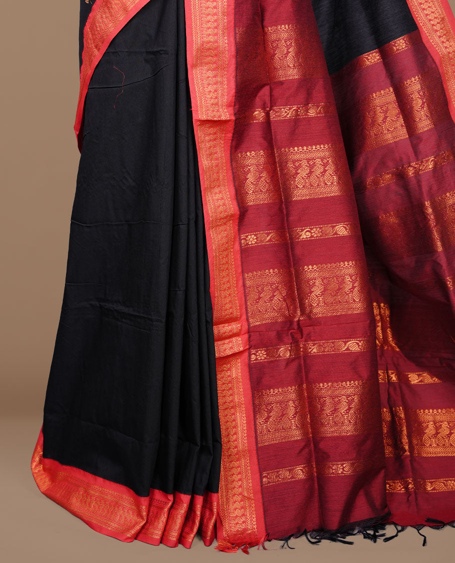 Black colour kalyani cotton saree featuring antique zari motifs on body, complemented by red colour with Antique zari border, paired with matching blouse piece.