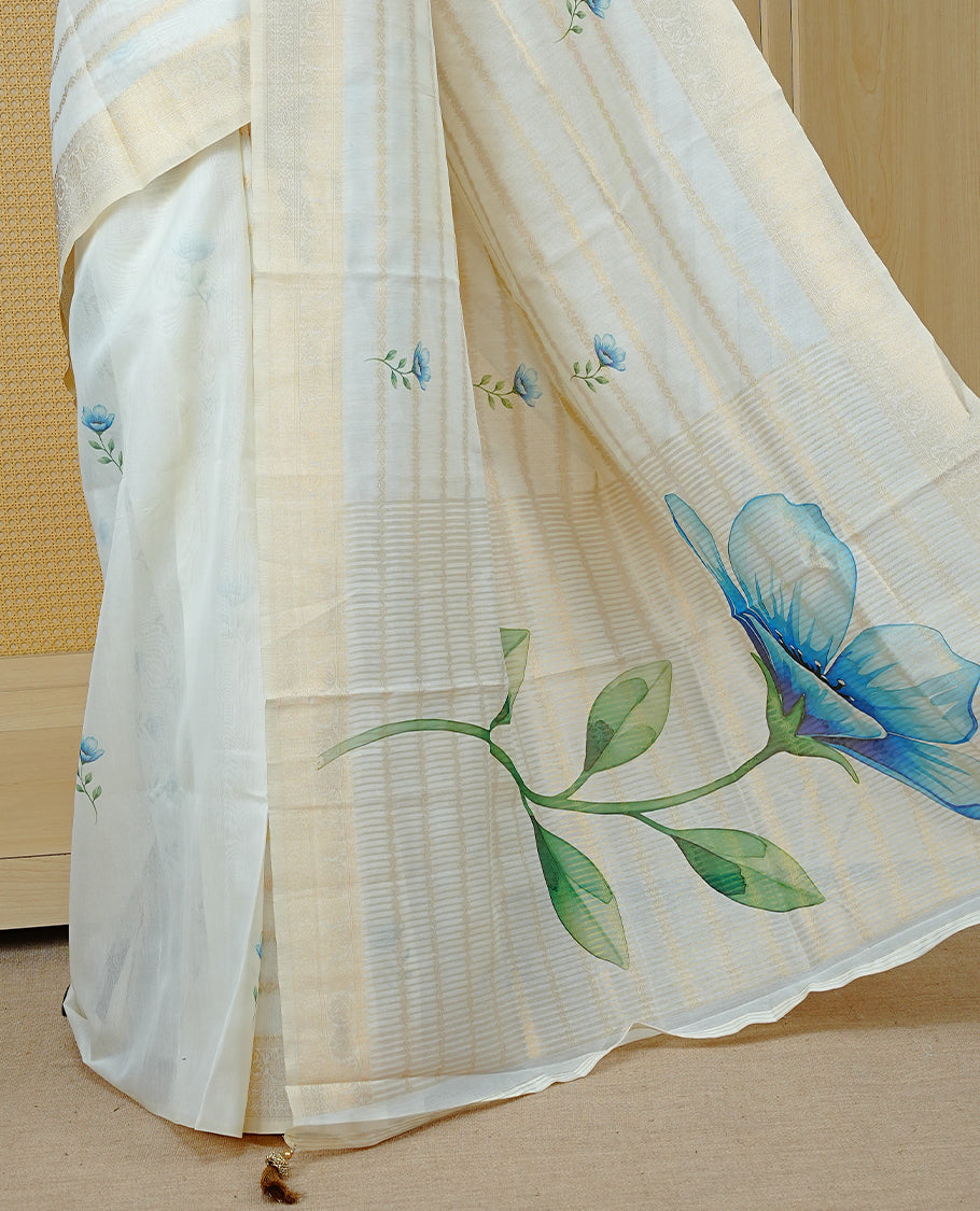 Cream Colour Organza Kerala Saree Featuring Gold Zari Strips with Floral Printed Motifs On The Body,Paired With A Matching Blouse Piece.