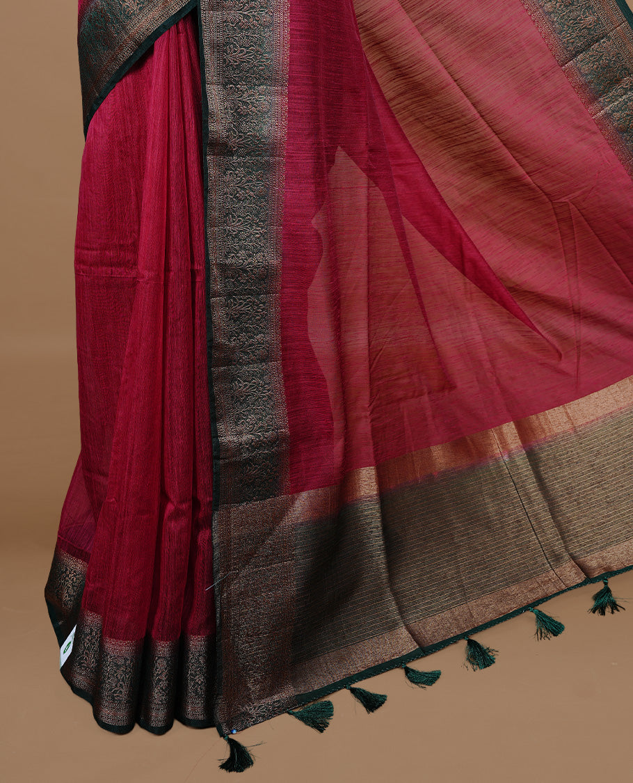 Maroon colour Semi linen saree featuring Elegant plain body, complemented by contrast Green colour With Antique zari border, paired with matching blouse piece.