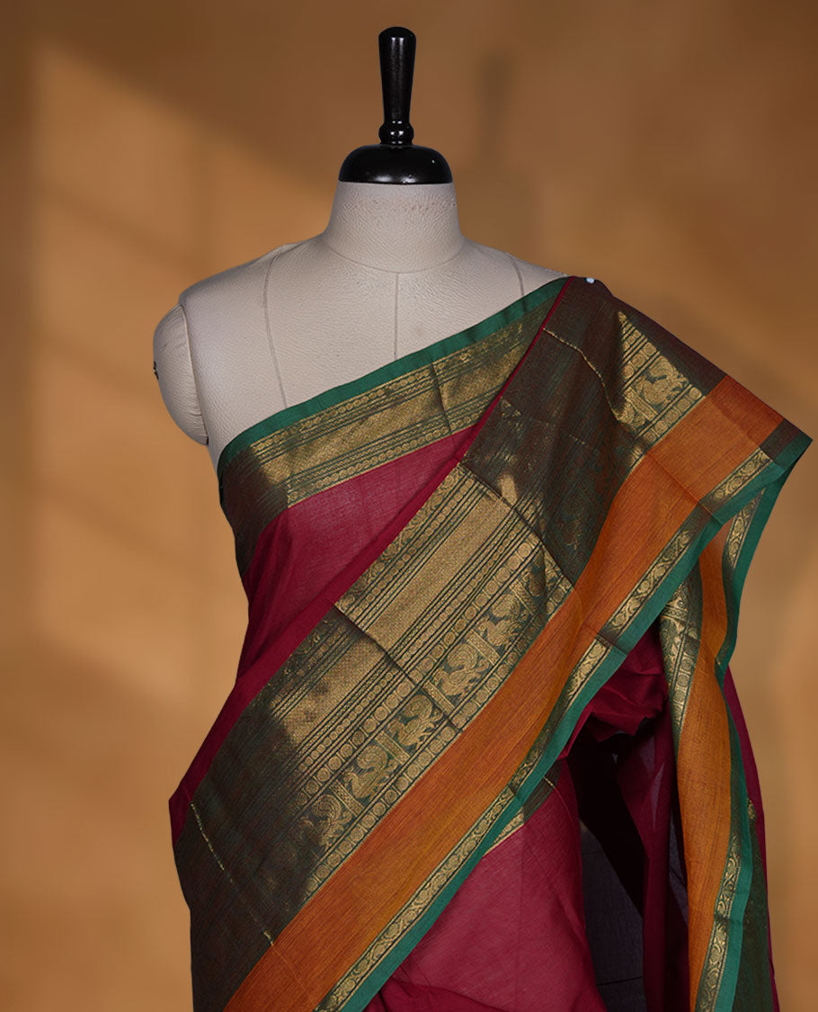 Red colour chettinad cotton saree featuring Elegant plain body highlighting contrast Green and mustrad colour colour with gold zari traditional border, pallu and paired with matching blouse piece.