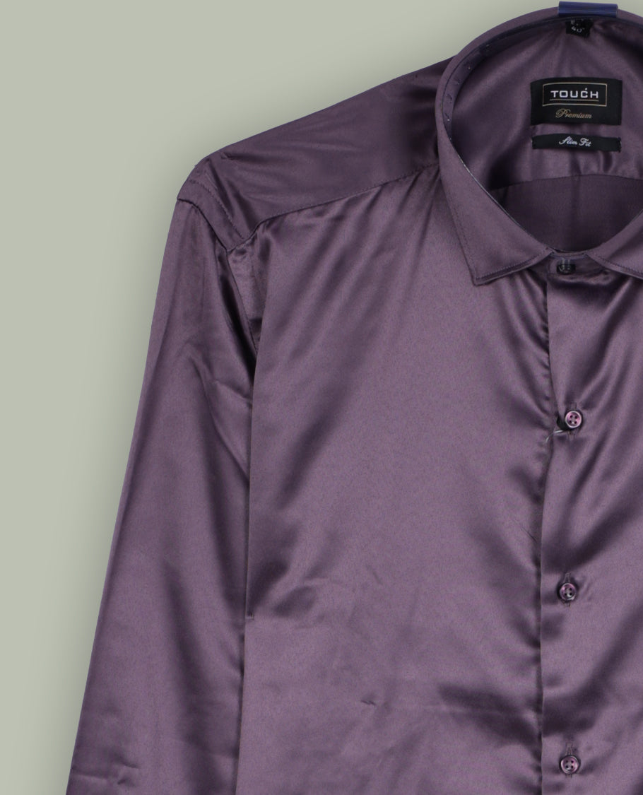 Rich purple colour satin shirt with a glossy finish, featuring a classic collar and full sleeves with broad cuffs, Designed with a front pocket and button-down style, adding a refined touch to formal or party looks.