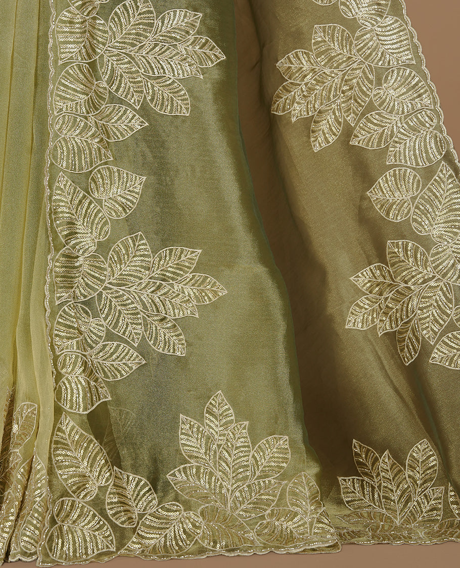 Green & gold double shade organza saree featuring thread & cut beats, sequins leaf pattern on body, highlighting scalp border, paired with matching blouse piece.