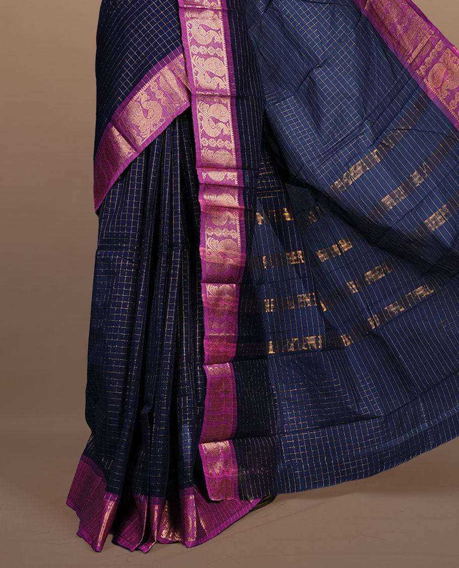 Navy blue colour sungudi cotton saree featuring gold zari check pattern across body, contrast Magenta colour with gold zari peacock and floral pattern on border, without blouse piece.
