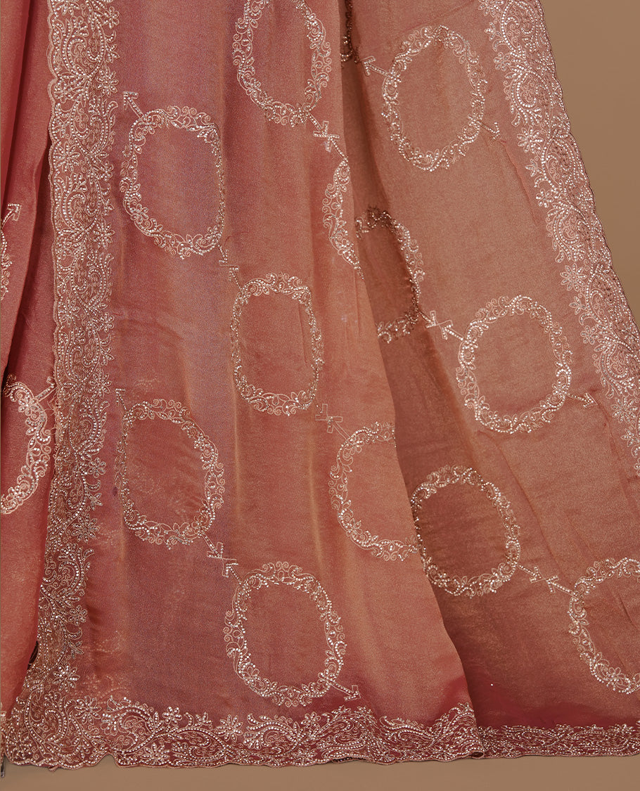 Pinkish orange colour organza saree featuring thread & gold stone pattern on body, highlighting scalp border, paired with Matching blouse piece.