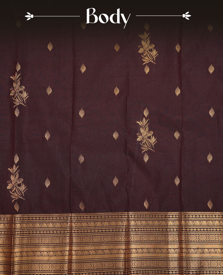 Chocolate colour soft silk saree featuring Gold zari motifs on body, complemented by self colour with traditional border, paired with matching blouse piece.