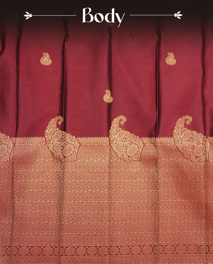 Maroon colour soft silk saree featuring motifs on body, complemented by self colour with traditional border, paired with contrast colour blouse piece.