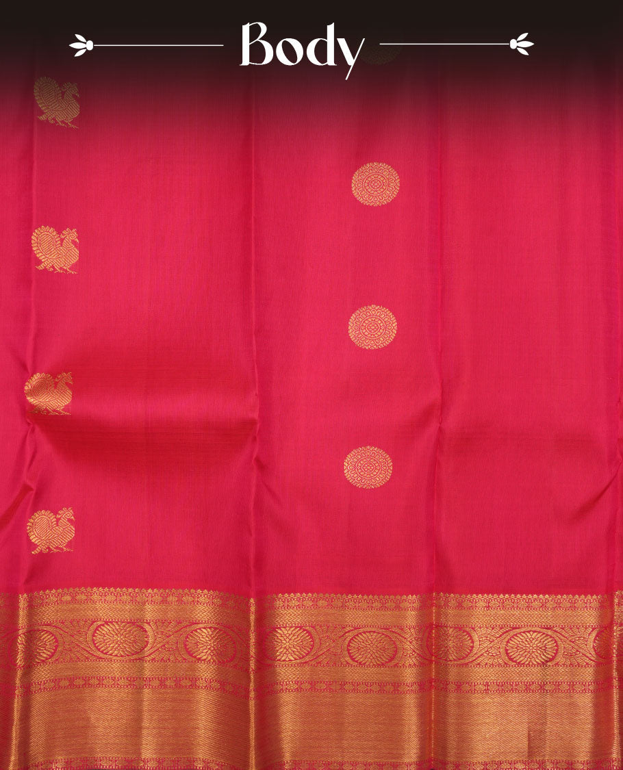 Rani pink colour pure traditional Kancheepuram silk saree adorned with gold zari peacock & chakra motifs across the body, featuring elegant traditional borders, beautifully paired with a matching blouse piece.