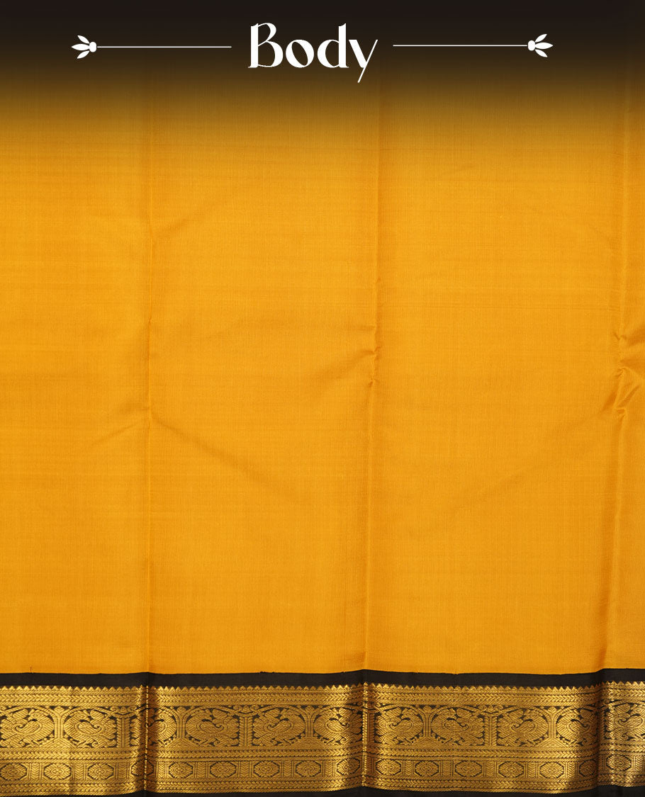 Mustard yellow colour pure traditional Kancheepuram silk saree featuring elegant contrast black zari traditional borders, beautifully paired with a matching blouse piece.