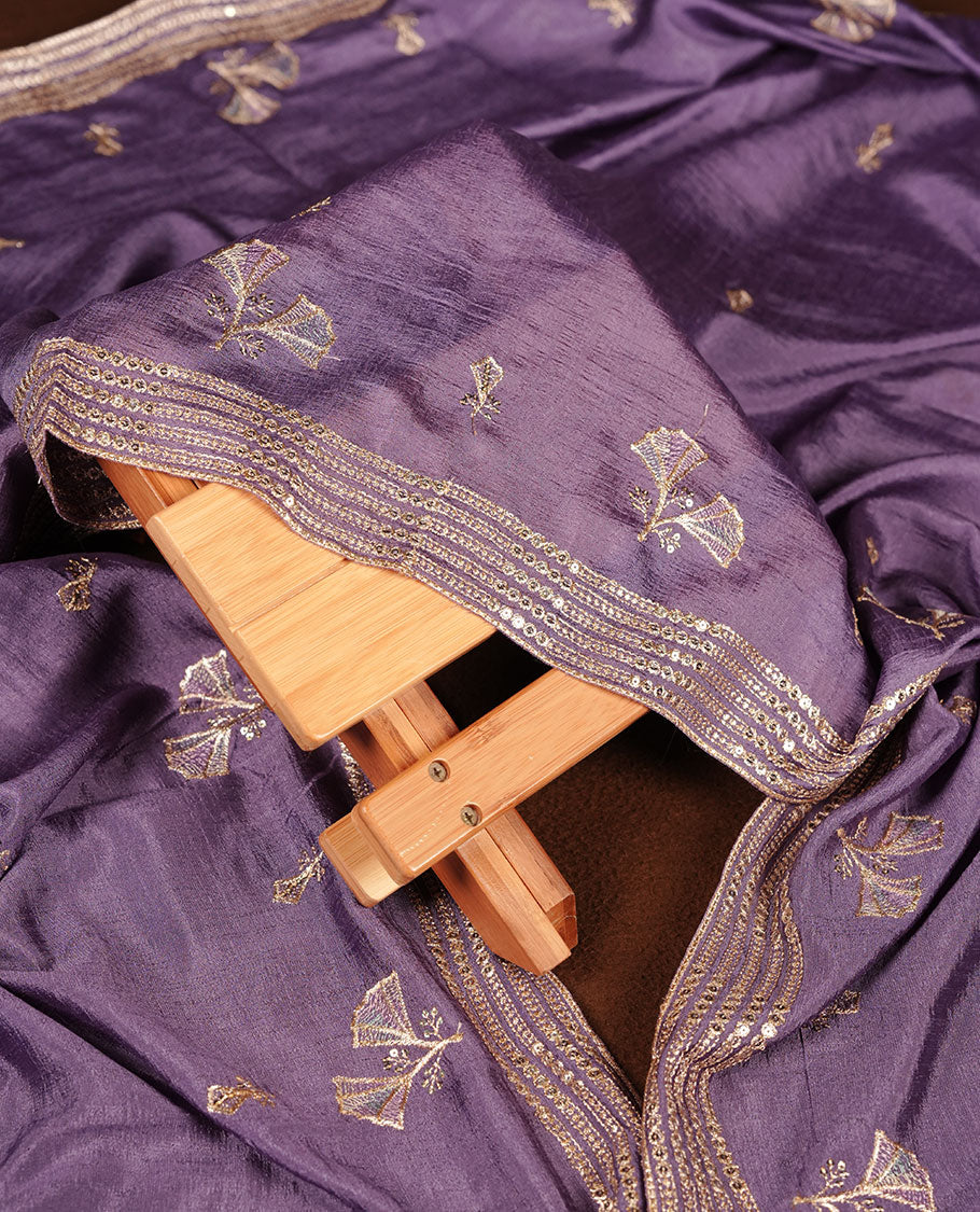 Lavender colour olive colour churidar material with subtle mirror and thread embroidery, finished with delicate border detailing and paired with a matching plain bottom and dupatta.