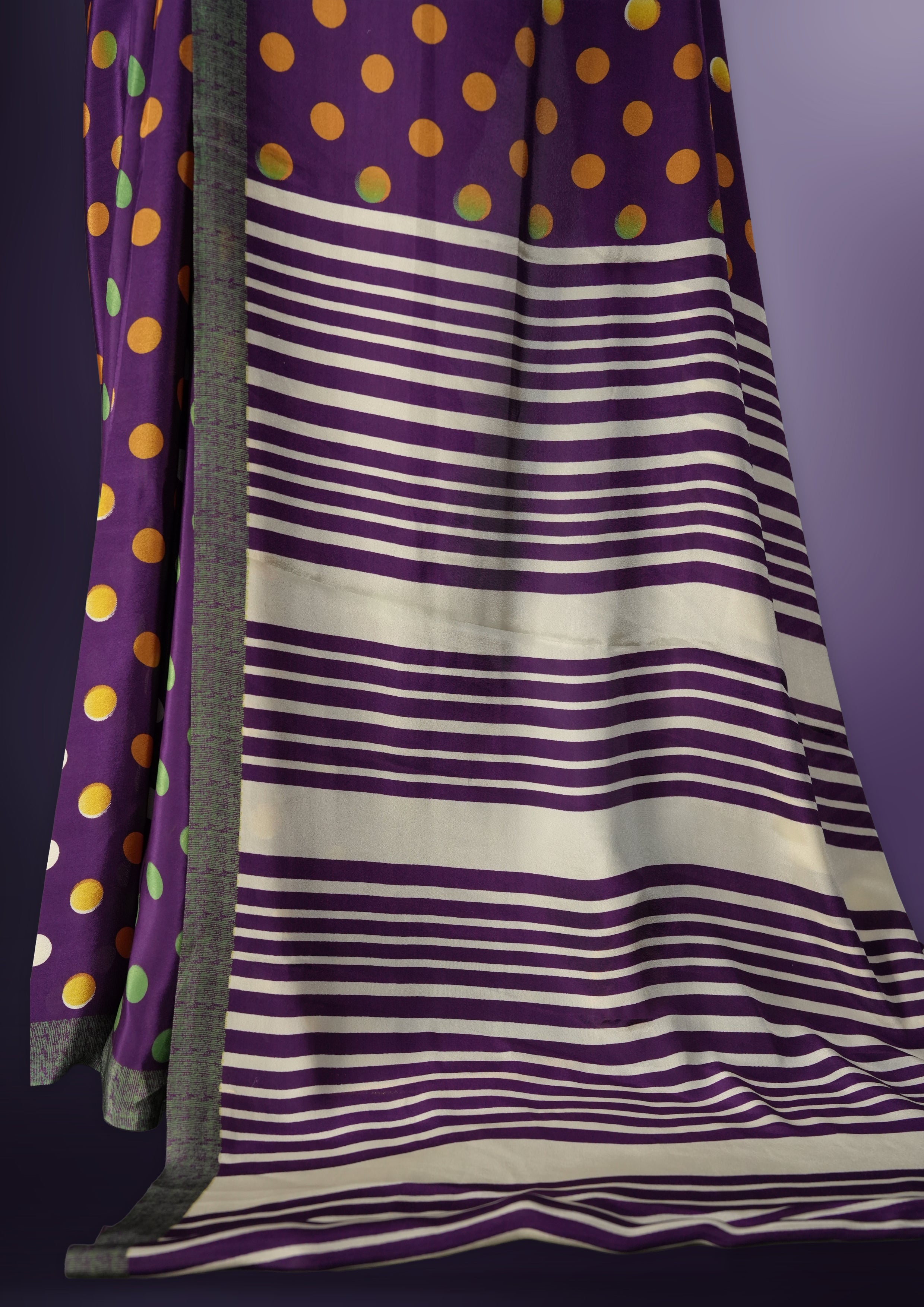 Purple colour saree with with large big polka dots on the body, self stripped pallu & Comes with a stylish matching blouse.