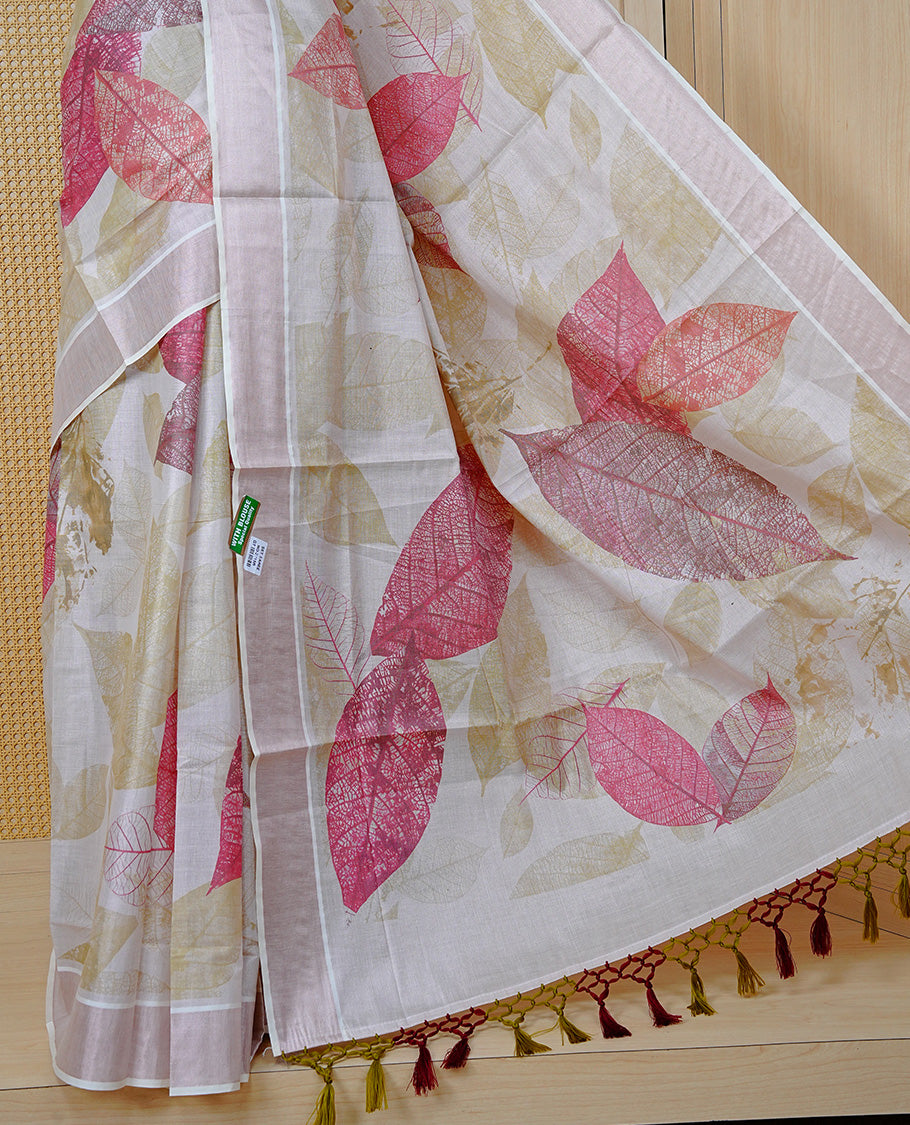 Cream Colour Tissue Kerala Saree Featuring A Digital Leaf Prints On Body & Pallu, Beautifully Enhanced With A Classic Rose Gold Zari Border And Olive Green & Maroon Tassels Paired With A Matching Blouse Piece.