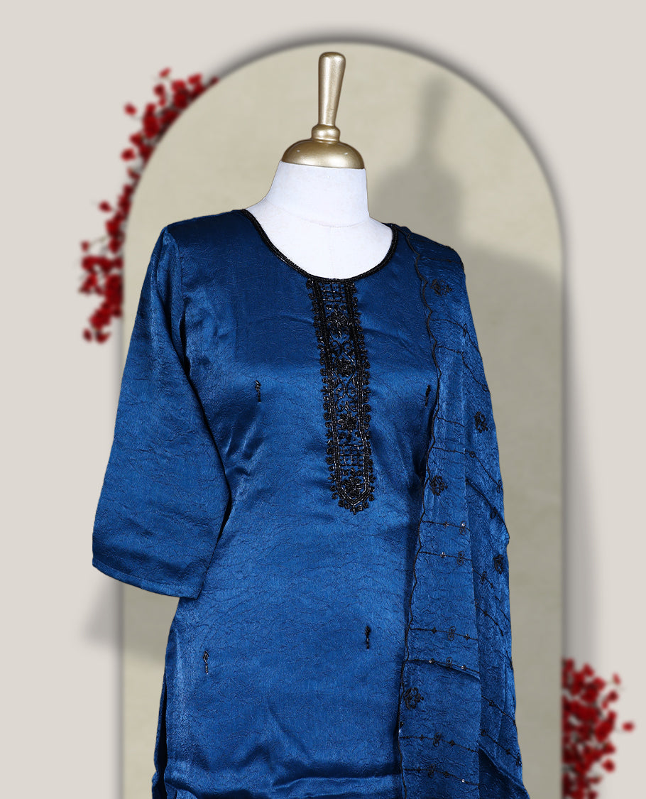 Blue churidar set adorned with intricate black cut bead work on the neckline, paired with a matching bottom & The set comes with a lightweight embroidered dupatta, adding elegance and charm to your ethnic look.