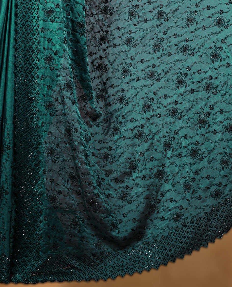 Dark pine green colour velvet chiffon designer saree, featuring black thread embroidery kodi pattern on body, black cut stone work and heavy stone border, pallu and Paired with matching blouse.