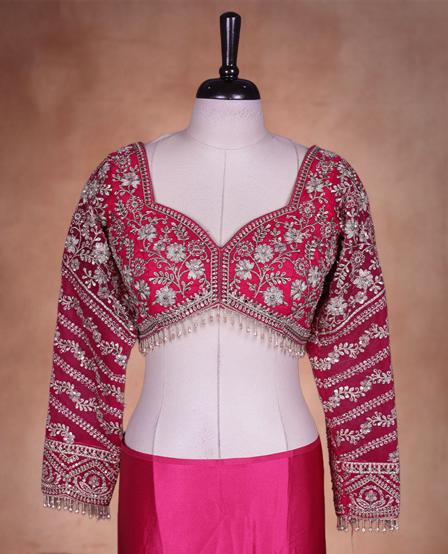 Rani Pink Colour net designer Wedding saree featuring all over floral embroidery with sequin detailing and an ornate scalloped border, finished with a matching embellished blouse.