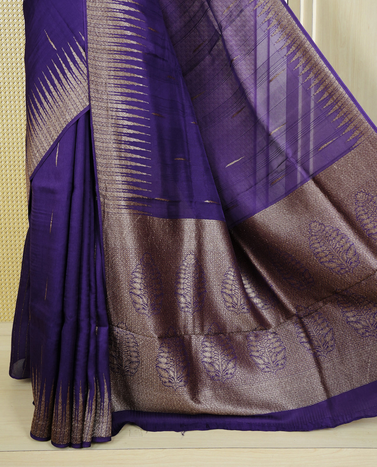 Rich purple colour semi banaras tussar georgette saree featuring gold zari pattern on body, finished with gold zari temple border and paired with matching blouse piece.