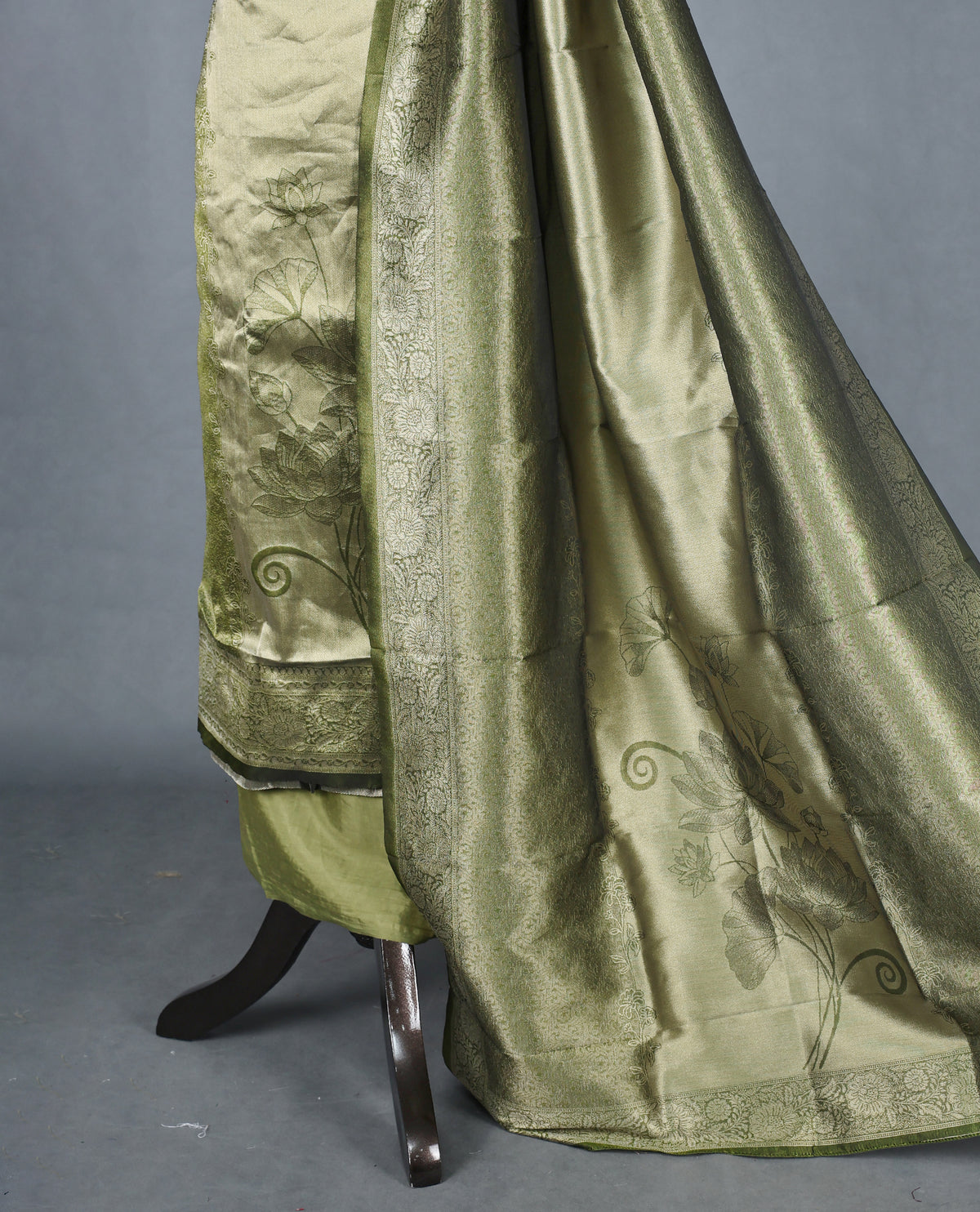 Green colour Tissue Salwar Material featuring subtle lotus floral motifs On Body ,paired with a matching bottom & graceful shaded Dupatta.