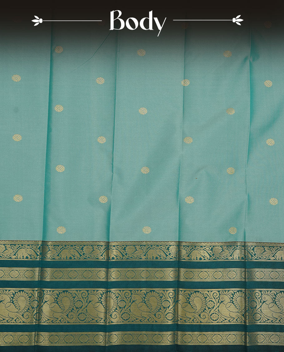 Aqua colour soft silk saree featuring gold zari motifs on body, complemented by contrast Teal colour with zari border, paired with matching blouse piece.