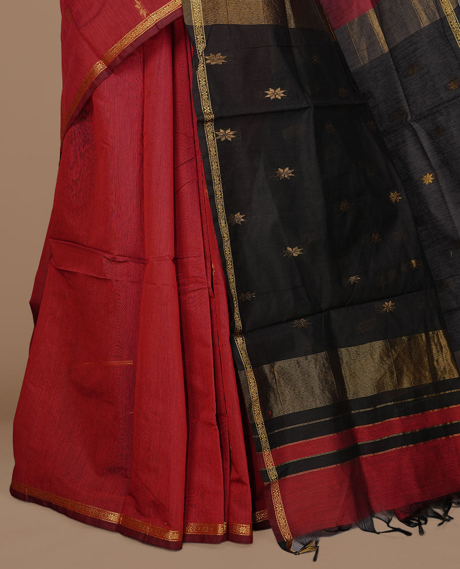 Maroon colour Maheshwari cotton saree features elegant gold zari motifs across the body, a classic gold zari border, a striking contrast pallu, and a matching blouse piece.