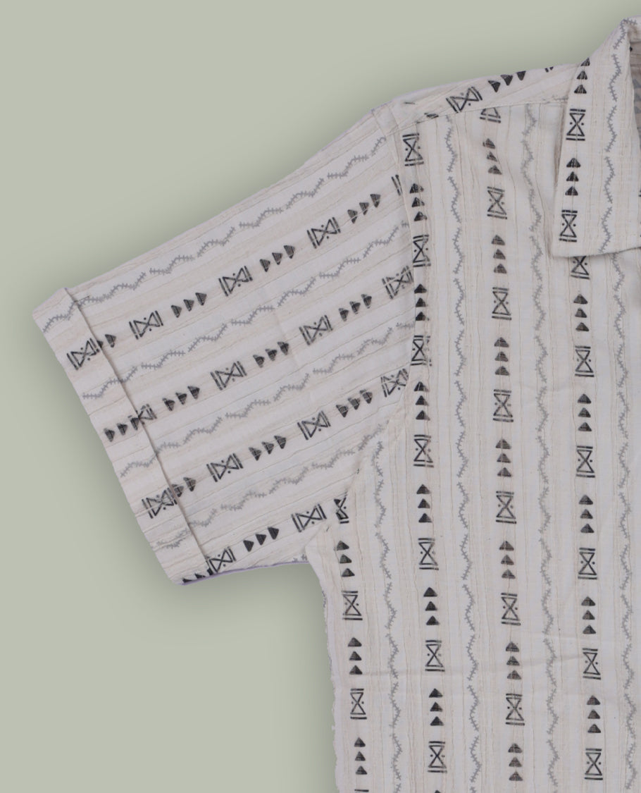 Off white colour shirt adorned with black geometric prints, Designed with a classic collar and short sleeves, it blends effortless style with everyday comfort.