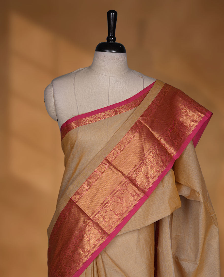 Beige colour chettinad cotton saree featuring Elegant plain body, contrast Magenta colour border with gold zari border, pallu and paired with matching blouse.