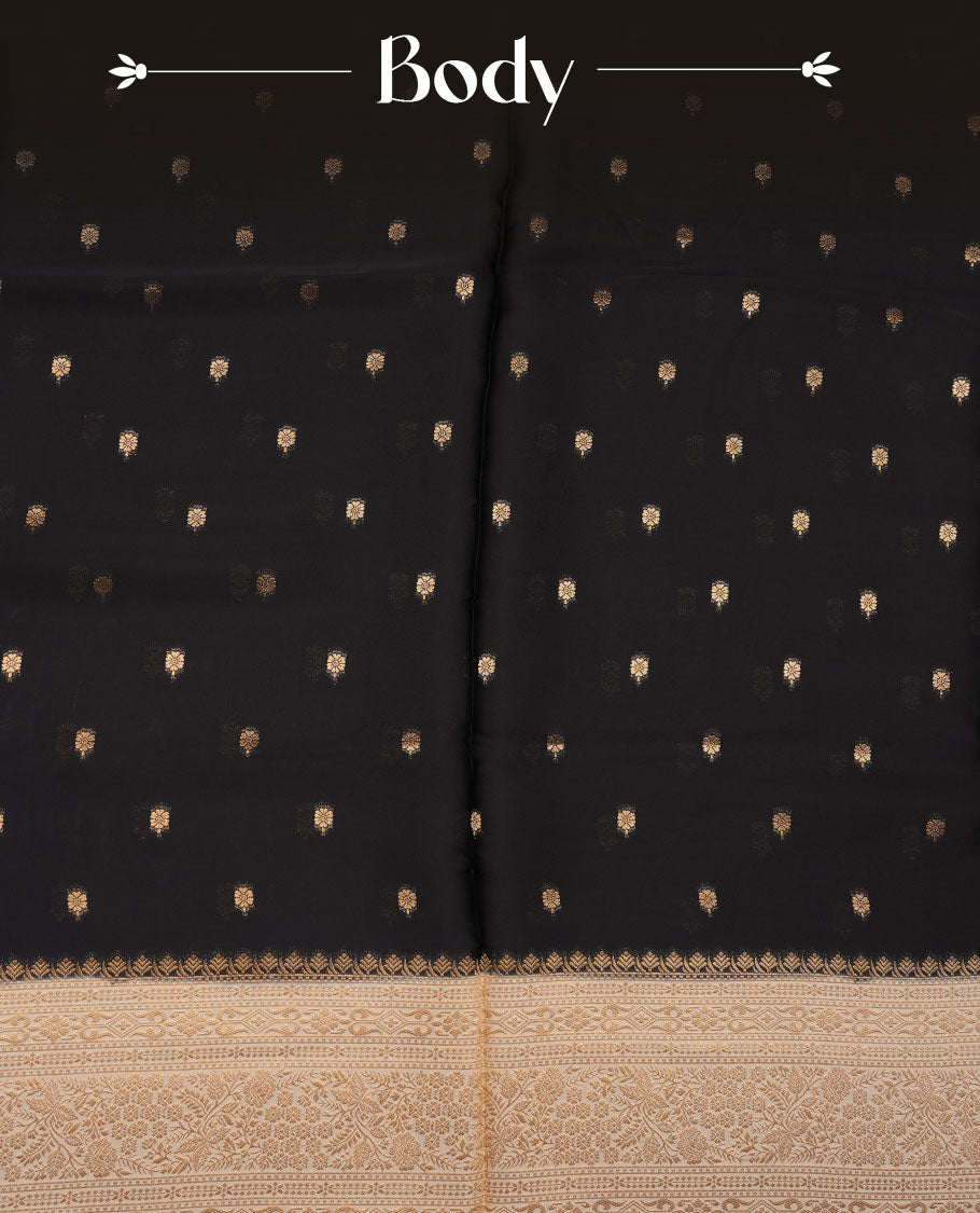 Black colour banaras satin crepe saree featuring gold zari motifs on body, with contrast cream colour border with gold zari pattern and paired with matching blouse.