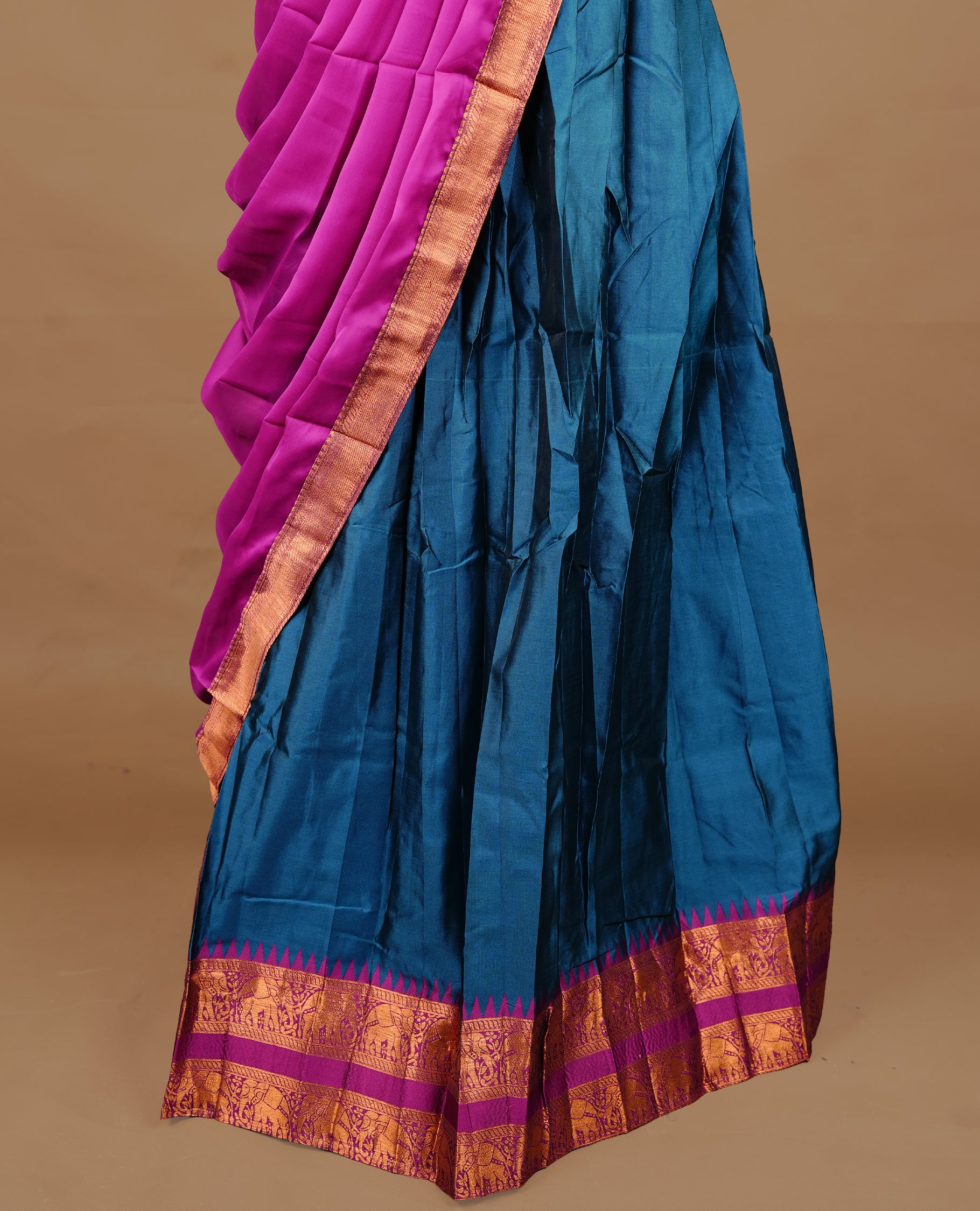 Teal colour semi stitched Half saree featuring contrast Magenta colour with gold zari traditional border skirt, paired with matching zari border dupatta, unstitched blouse piece