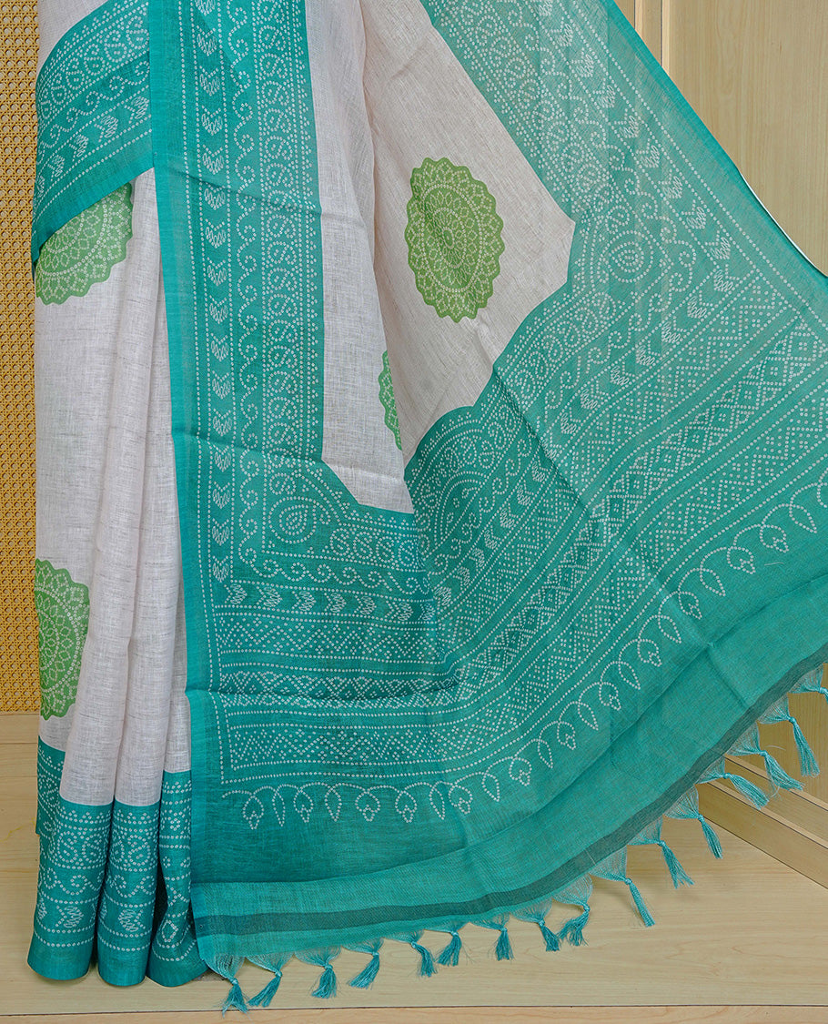 Cream colour semi linen saree featuring Light green Ajrakh pattern print on body, complemented by contrast green colour with same pattern print border, comes with matching blouse piece.