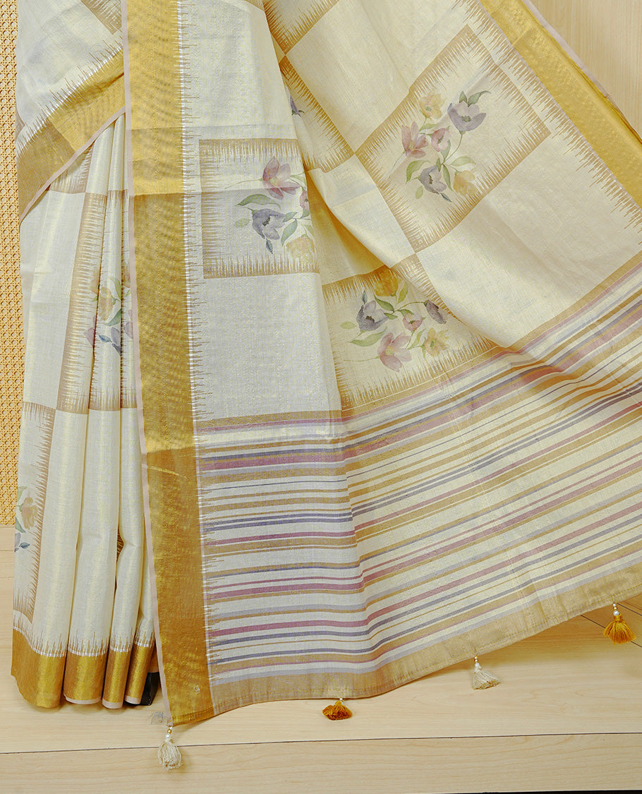 Cream Colour Tissue Kerala Saree Featuring Soft Floral Prints in a Classic Rectangle Pattern On Body, Enhanced with a Rich Gold Zari Border and a Striped Pallu. Finished with Elegant Tassels and Paired with a Matching Blouse Piece.