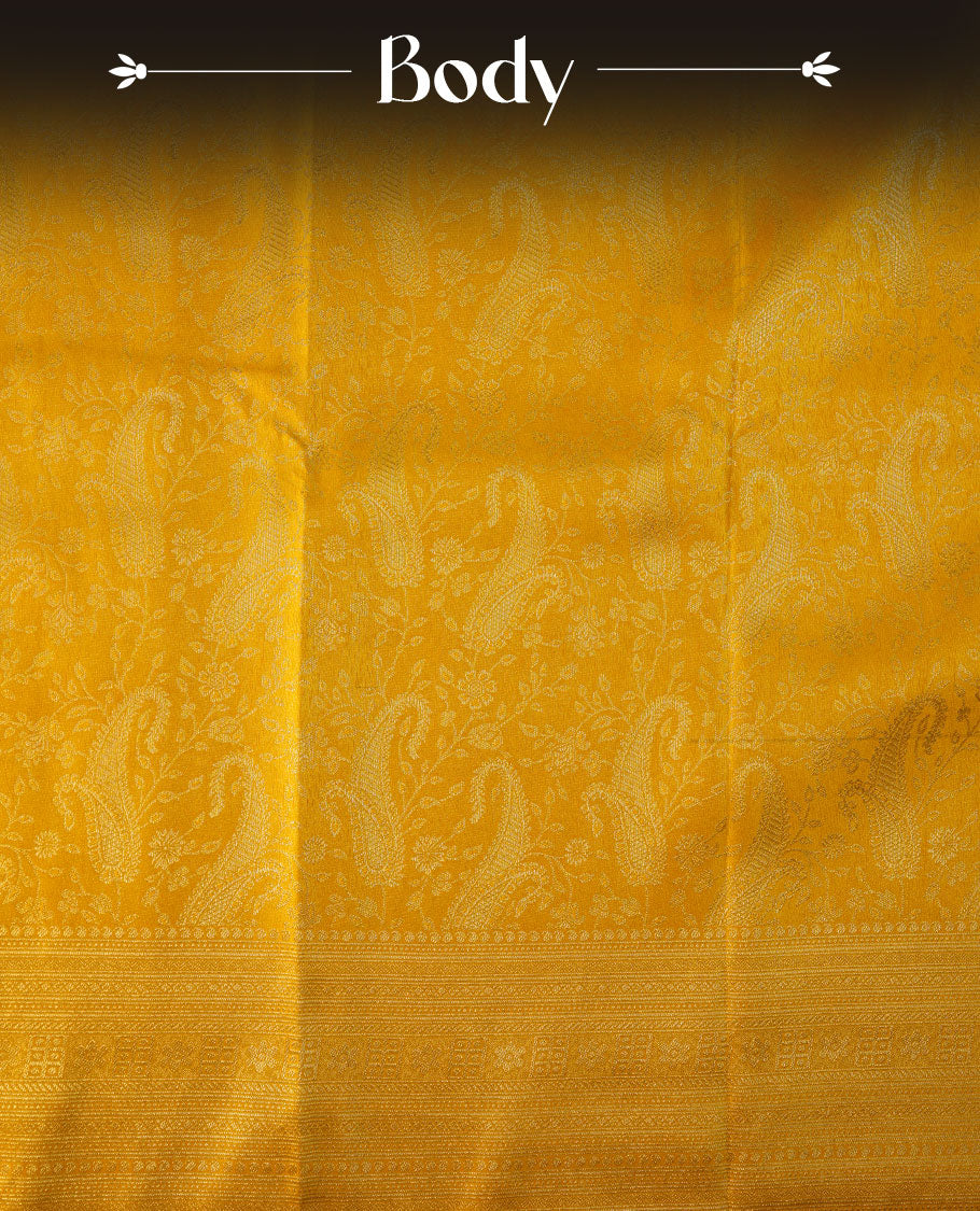 Mustard yellow colour semi soft silk brocade saree featuring subtle self-woven paisley motifs on the body, finished with an intricately woven matching border and pallu, paired with a coordinating blouse piece.
