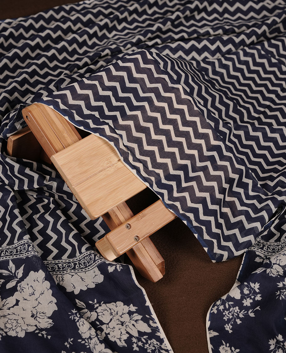 Blue colour churidar set with cream floral print, stone and thread embroidery and detailing, paired with matching pant and dupatta.