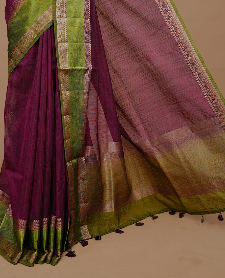 Maroon colour Semi linen saree featuring Elegant plain body, complemented by contrast Green colour With Antique zari border, paired with matching blouse piece.