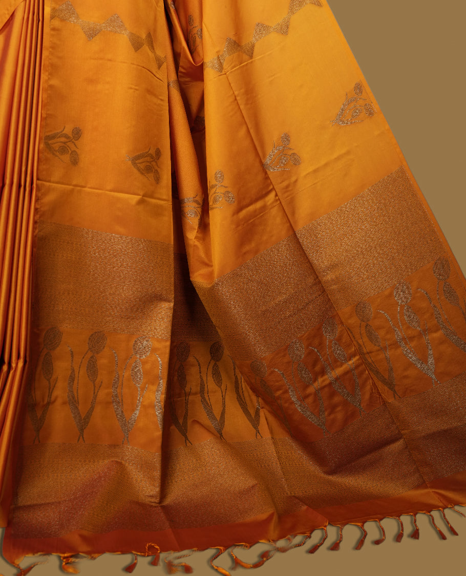Mustard yellow colour semi soft silk saree, adorned with subtle woven motifs on the body & The design is elevated with an elegant zari border and pallu, paired with a matching blouse.