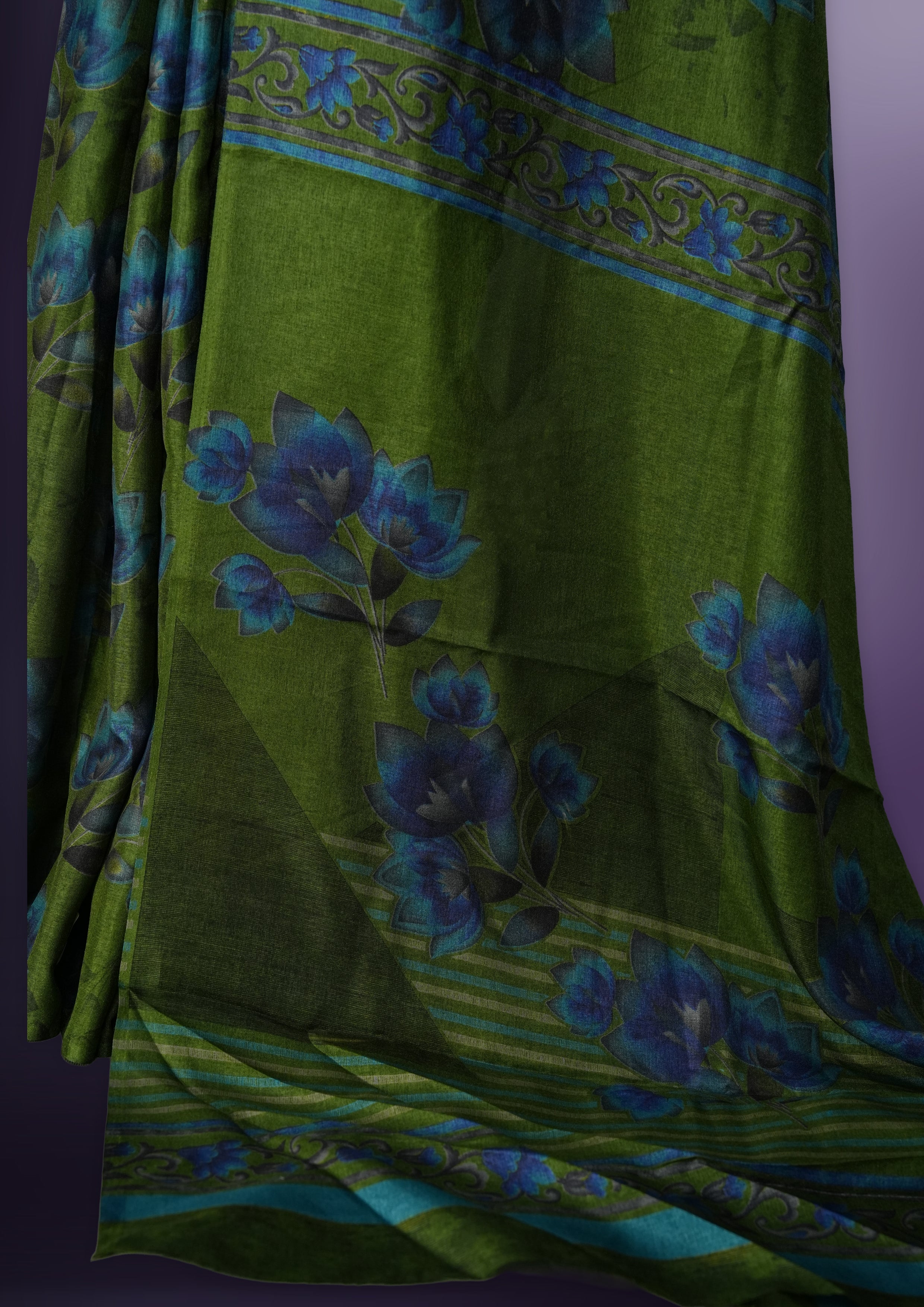 Green colour saree enhanced with a vibrant blue colour floral prints on body & pallu, and comes with a matching blouse.