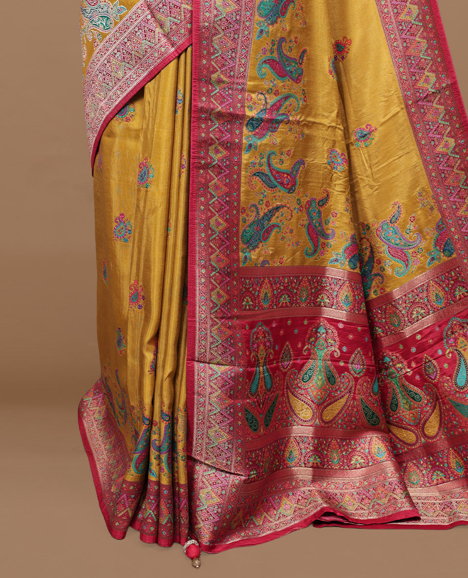 Mustard colour pashmina silk saree features all over motifs on body, contrast red with multi colour geometric border, paired with matching unstitched blouse blouse.