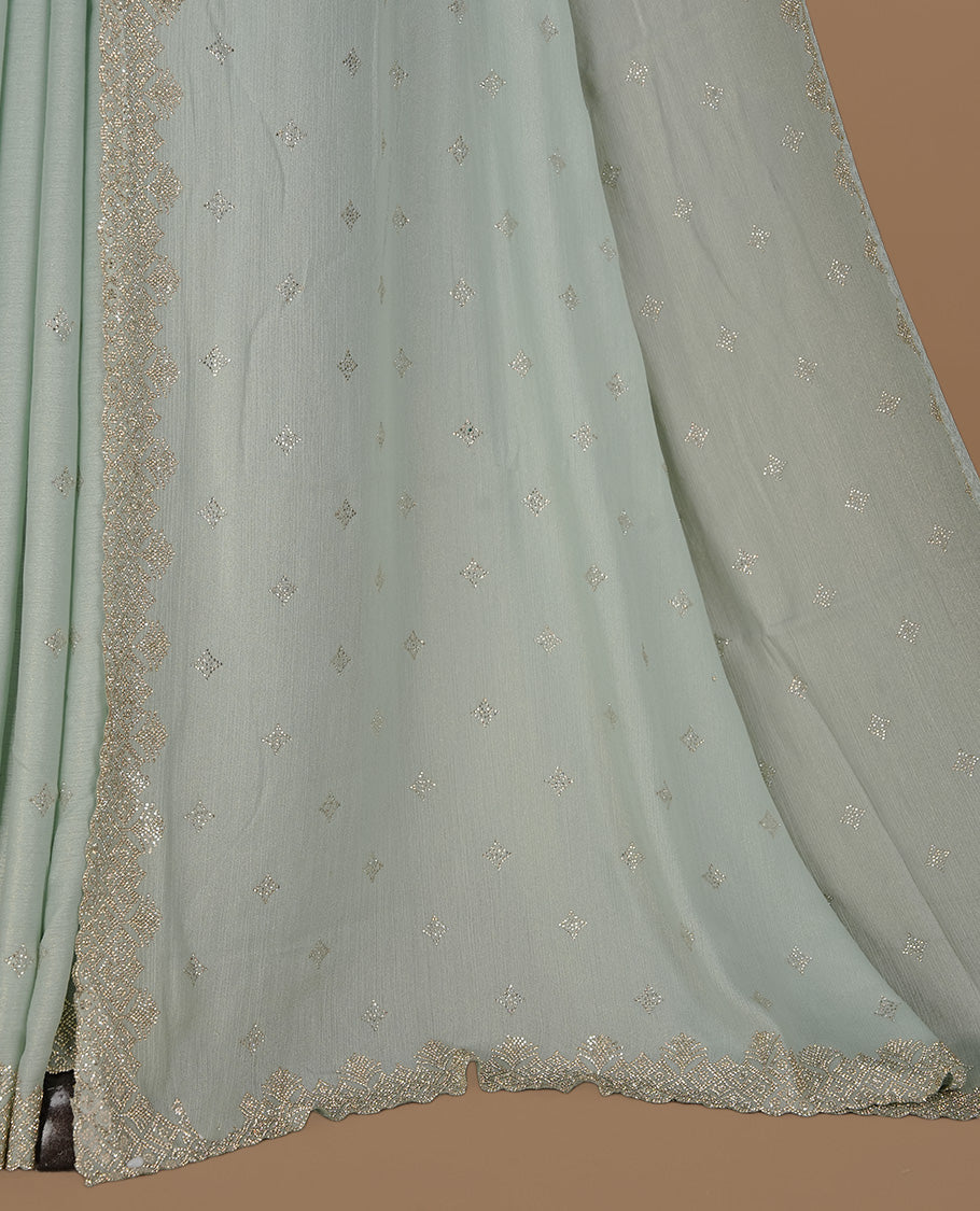 Mint colour organza designer saree featuring Gold stone motifs on body, highlighting light weight stone worked border, paired with matching blouse piece.