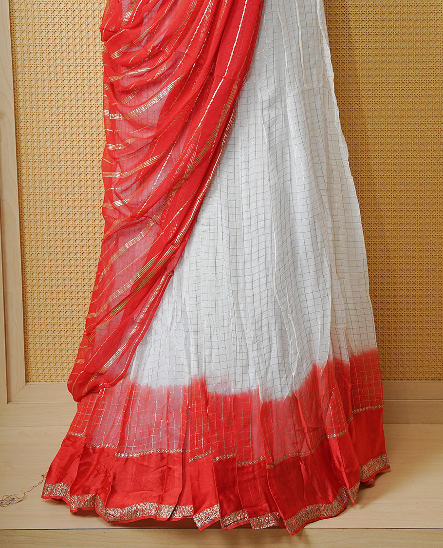 Off white colour Semi stitched dhavani set featuring Gold zari check pattern with contrast Orange border skirt, paired with matching blouse & dupatta.