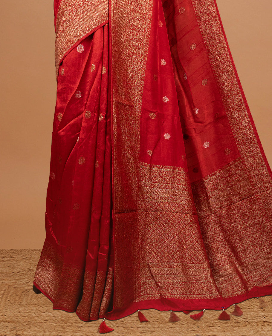Red colour Semi banaras tussar georgette Saree featuring Antique zari motifs on body, enhanced with antique zari border, paired with a matching blouse piece.