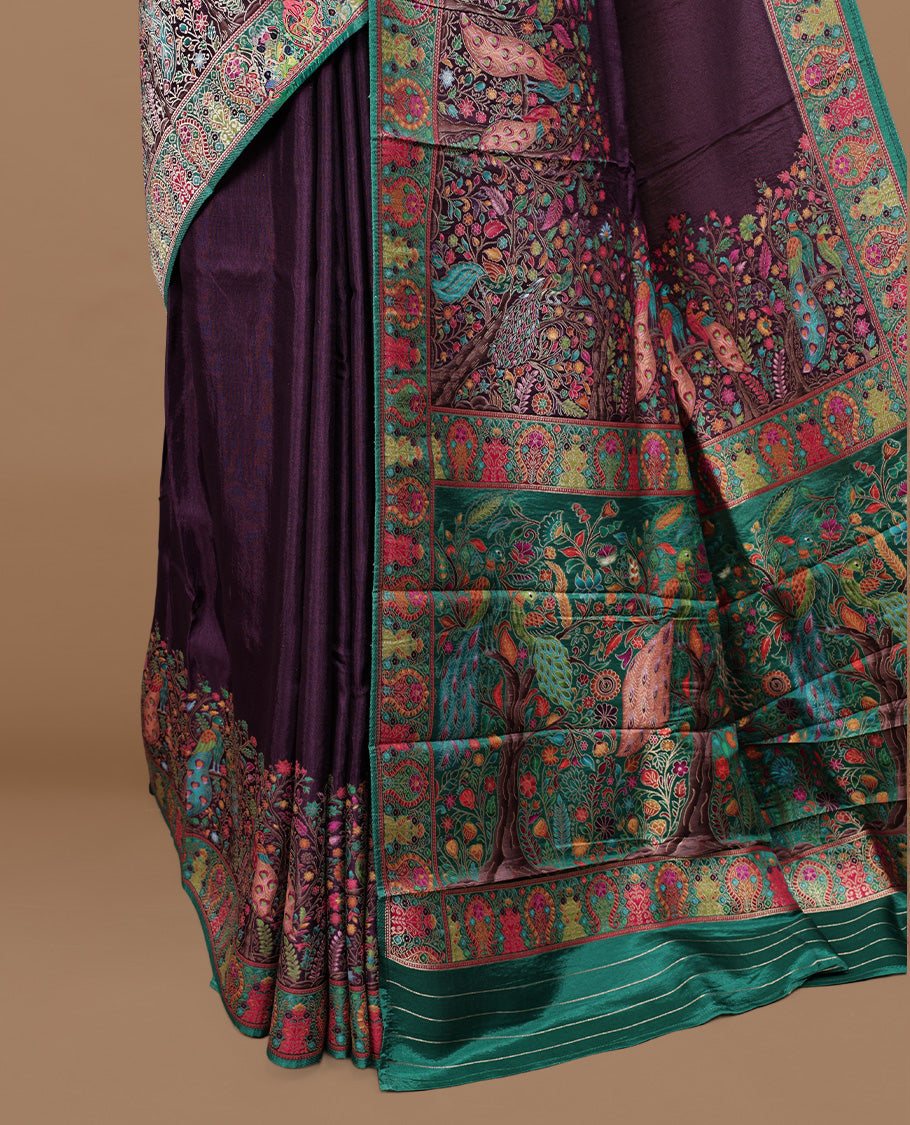 Deep Purple Pashmina silk saree featuring floral Pattern body, complemented by red border with multi colour Peacock & floral motifs, complete with matching blouse piece.