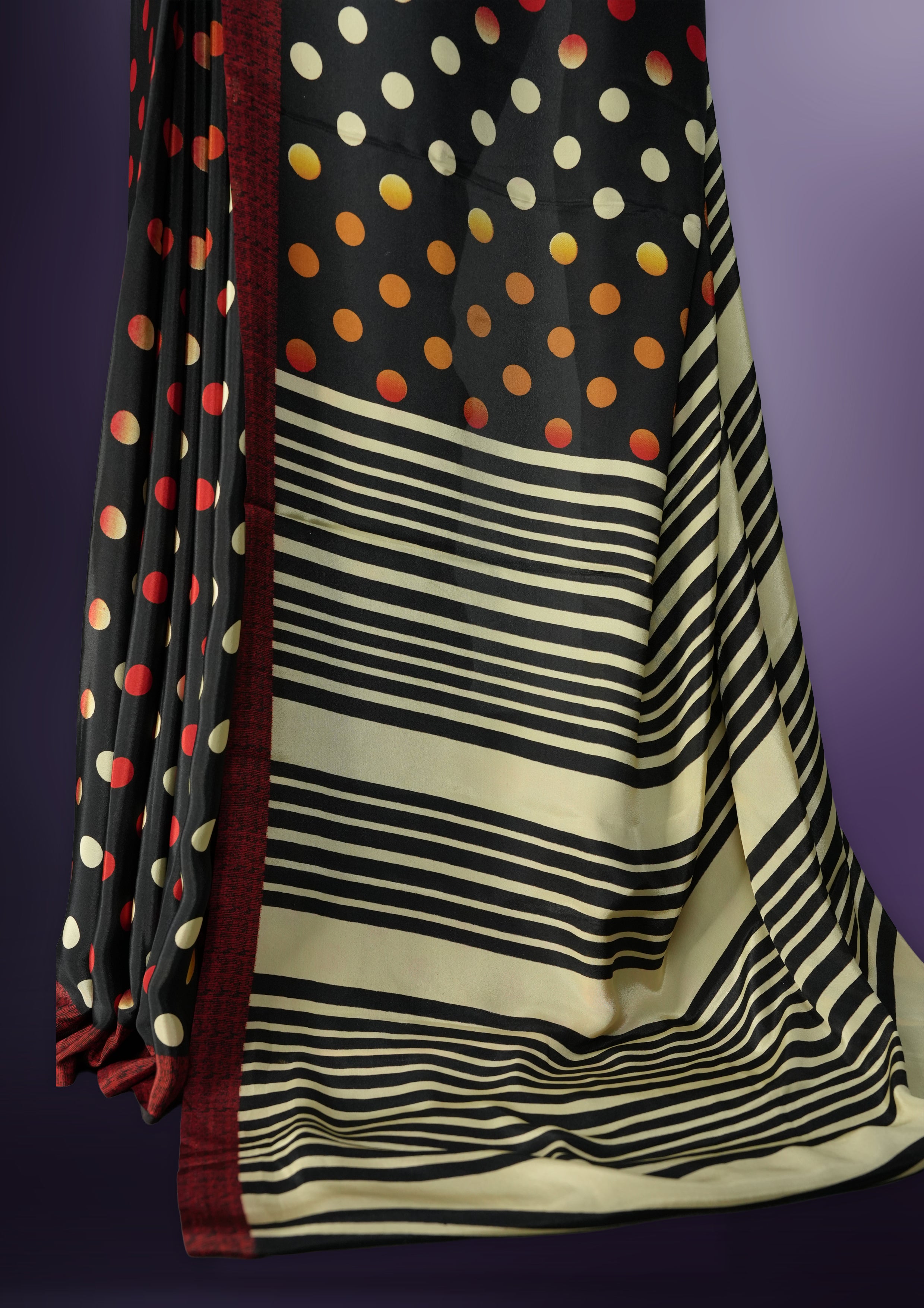 Black colour saree with with large big polka dots on the body, self stripped pallu & Comes with a stylish matching blouse.