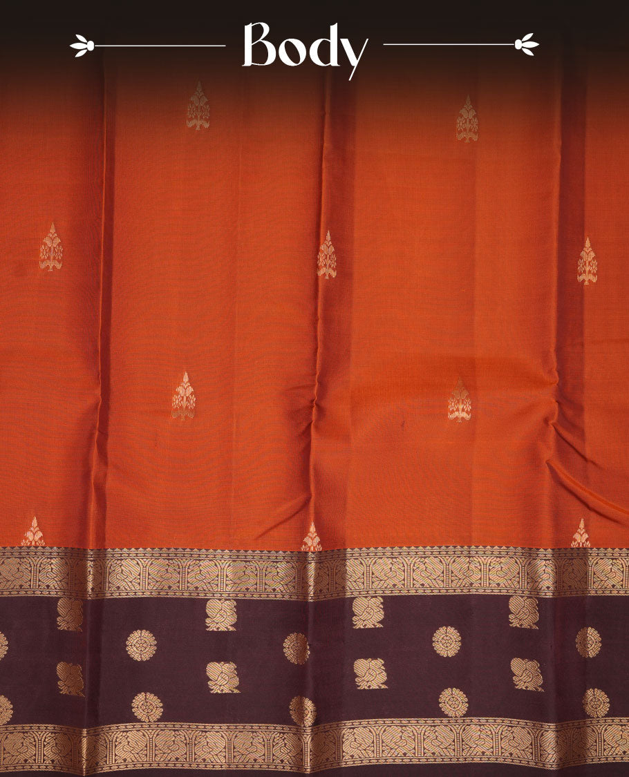 Brick red colour Vasundhara silk saree featuring zari motifs on body, complemented by contrast coffee brown colour with zari buttas border, paired with matching.