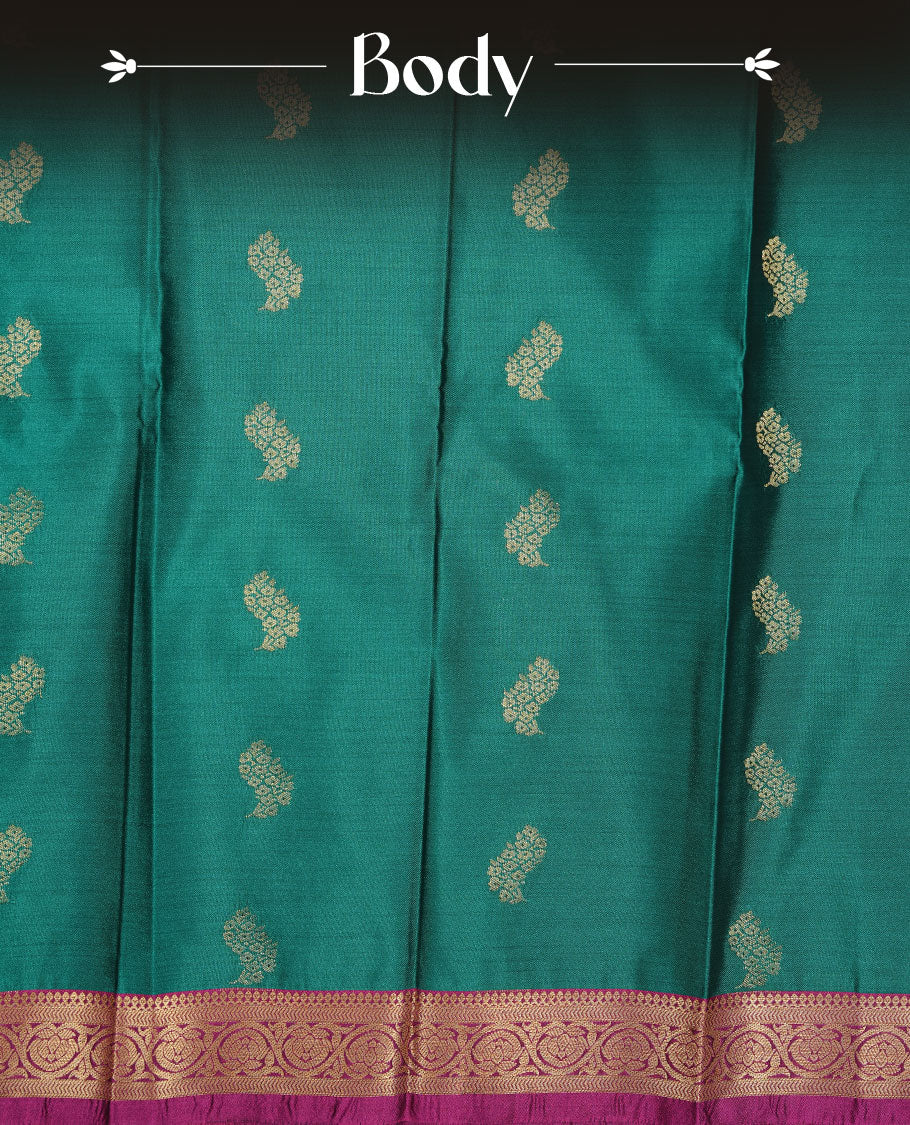 Teal colour soft silk saree featuring Gold zari motifs on body, complemented by contrast Magenta colour with traditional border, paired with matching blouse piece.